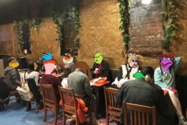 A photo of cartoonists with their heads replaced with drawings of the Muppets