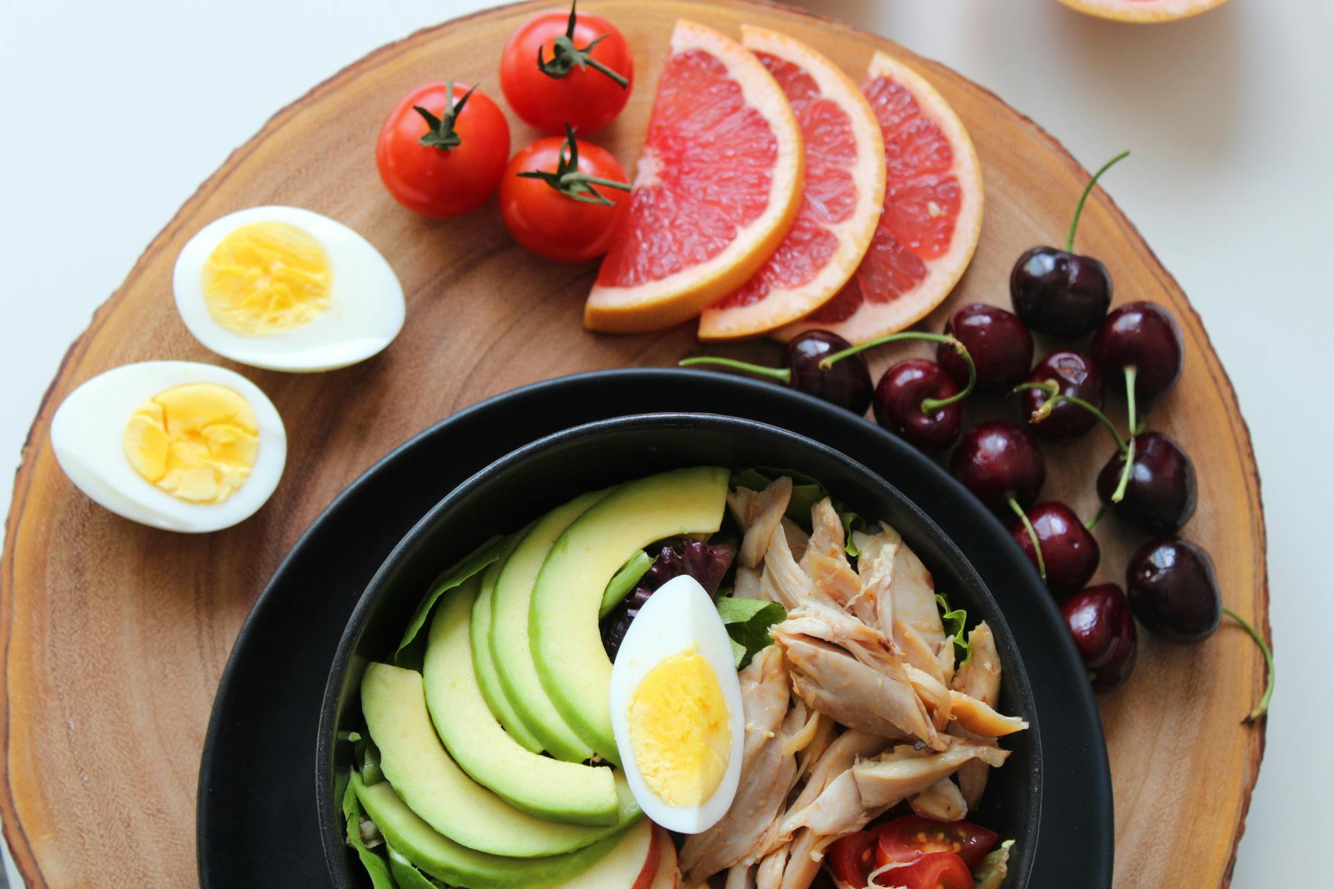 A spread of fruit, eggs and a salad bowl